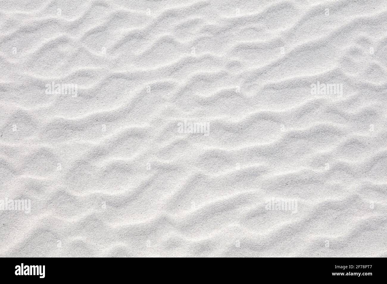 Abstract irregular pattern in white sand on beach. Textured summer background. Holiday at sea