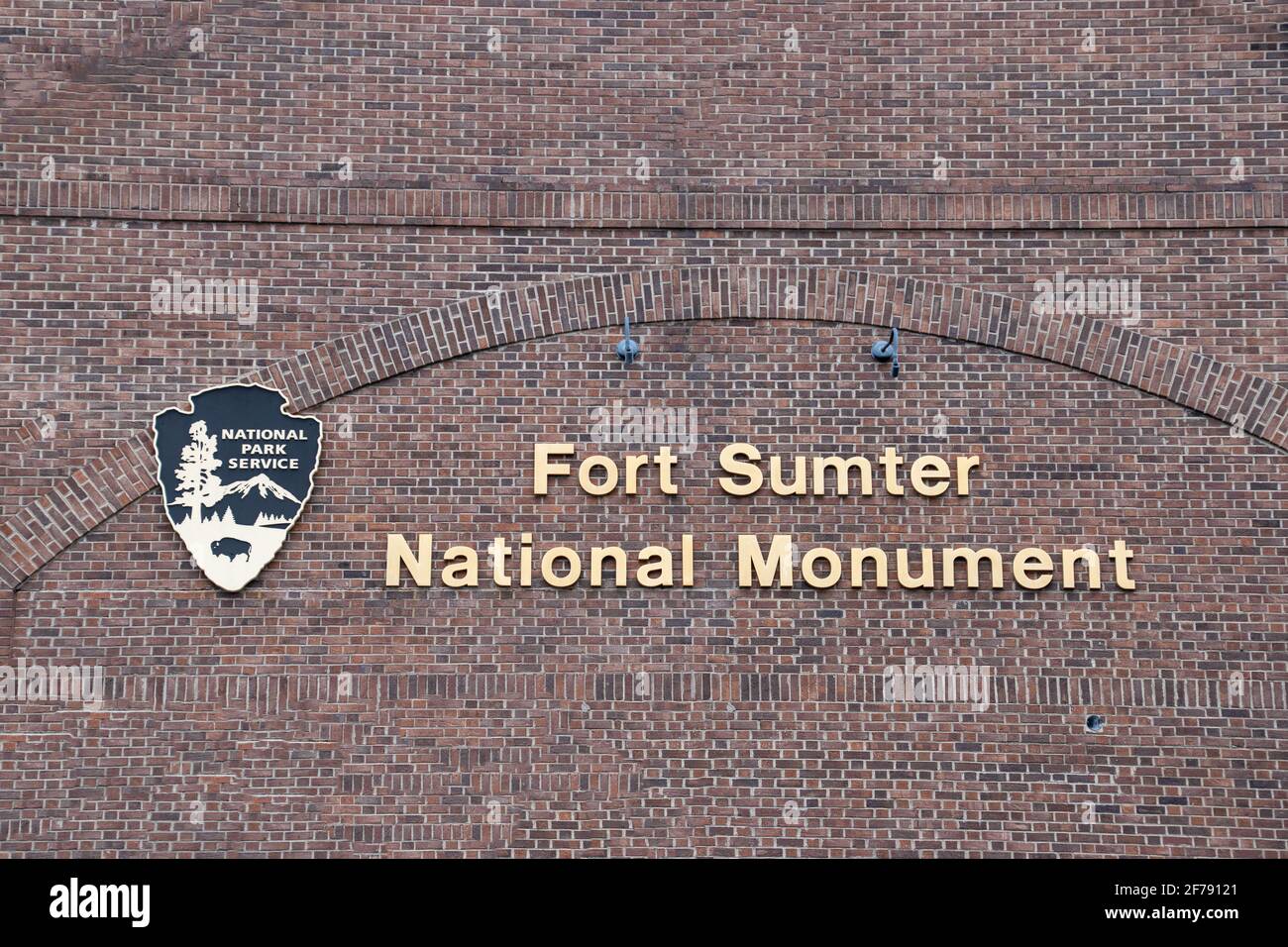 A sign for Fort Sumpter National Monument on a brick façade Stock Photo