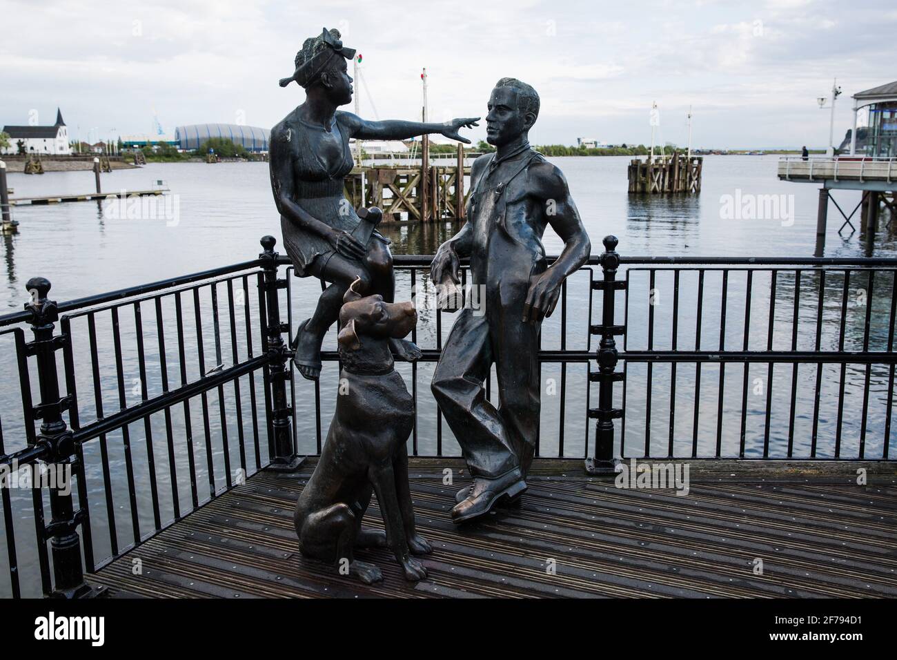 Cardiff, UK. 1st May, 2017.  A bronze sculpture of a young couple and a dog by John Clinch is pictured on Mermaid Quay with Cardiff Bay behind. The sculpture, created in 1993 and named 'People Like Us', represents the people who lived and worked in the area which was previously known as ÕTiger Bay'. Credit: Mark Kerrison/Alamy Live News Stock Photo