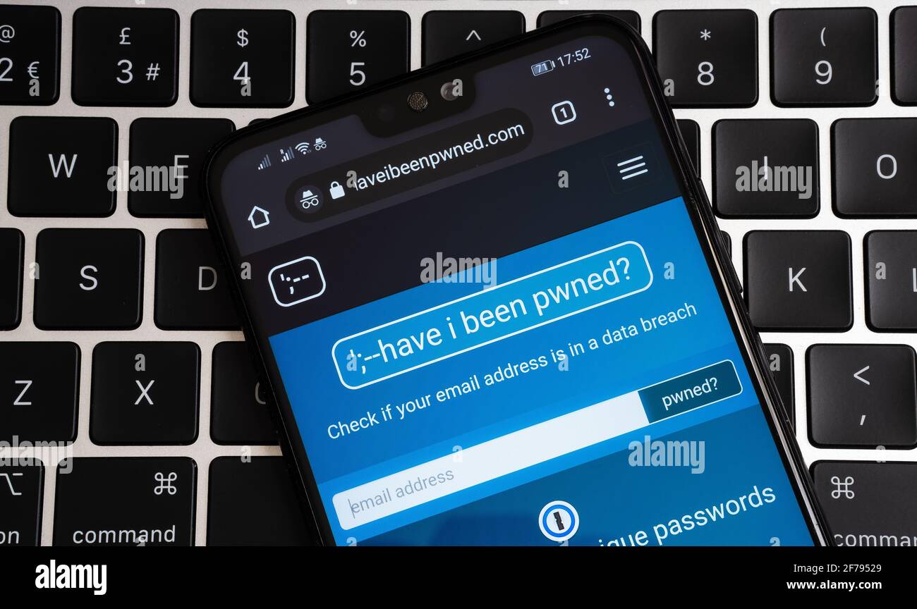 Web site 'Have I been pwned' seen on the smartphone on keyboard. Service that check if your email and facebook account have been compromised in data l Stock Photo