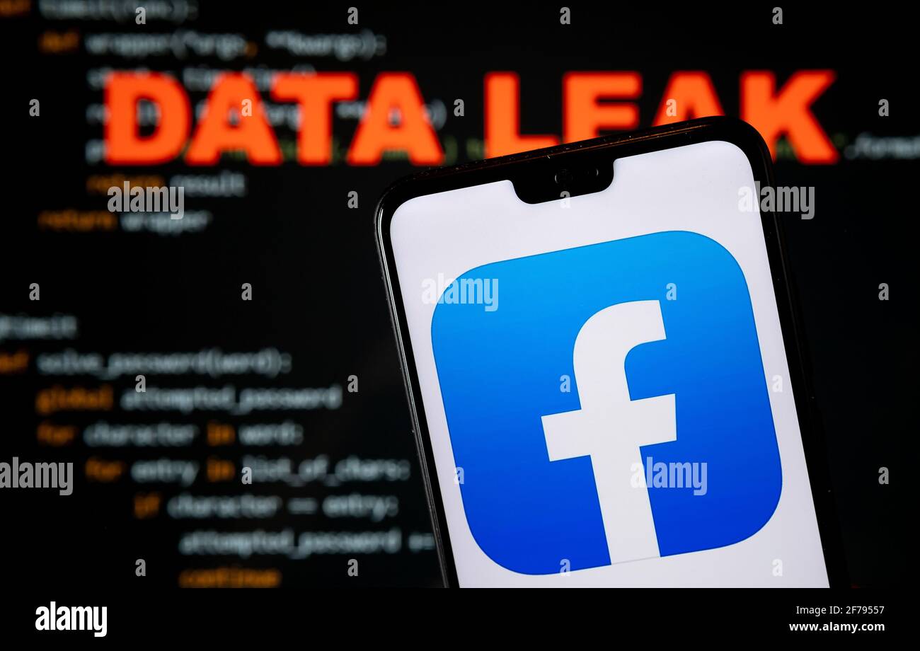 Facebook Data Leak. Facebook app logo seen on the smartphone and blurred HACKED word with a brute force script on the blurred background. Concept for Stock Photo