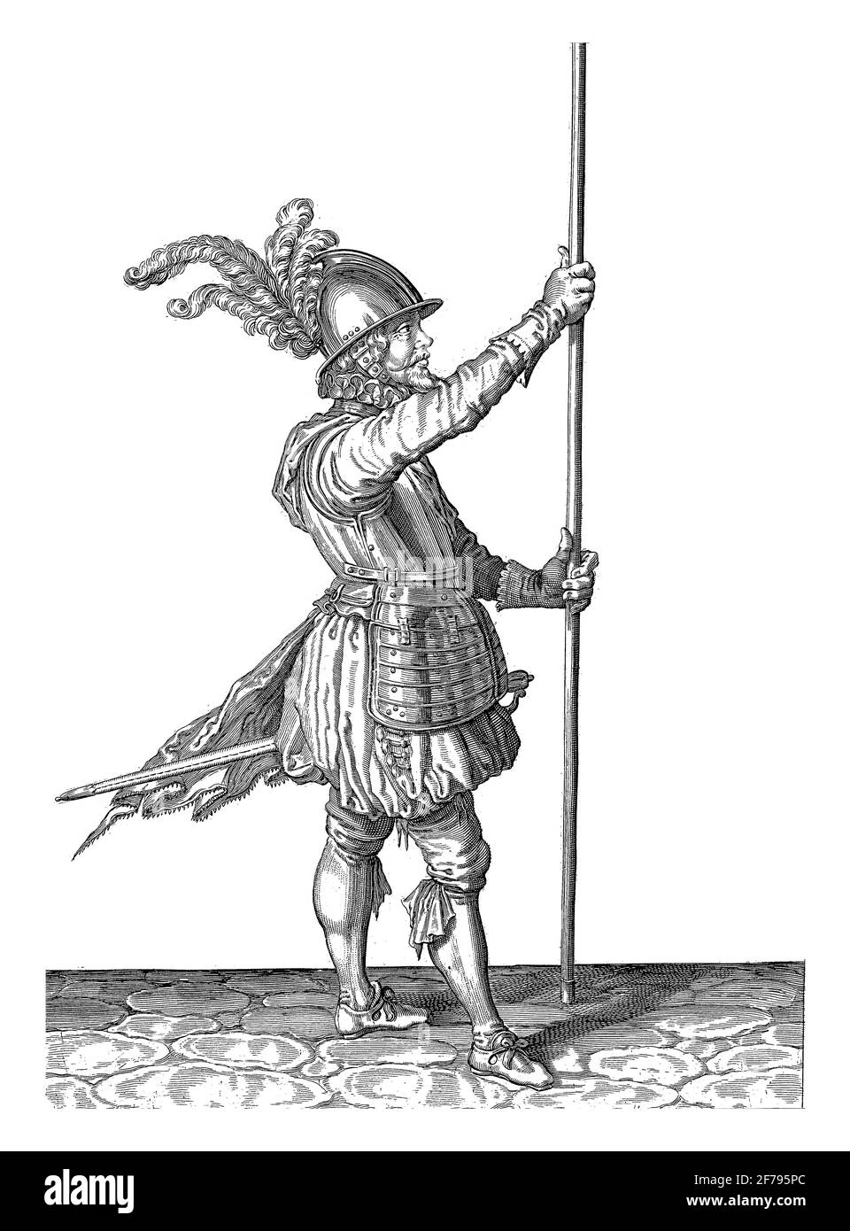 A soldier, full-length, to the right, holding a skewer (lance) with both hands upright in front of him slightly above the ground, vintage engraving. Stock Photo