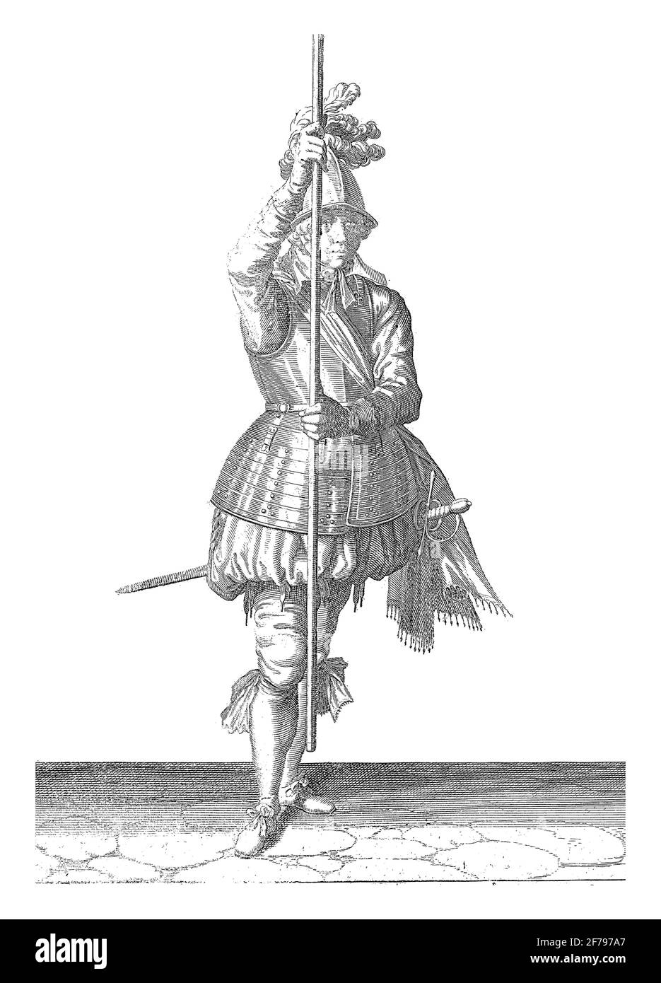A full-length soldier holding a skewer (lance) with both hands upright slightly above the ground in front of him, vintage engraving. Stock Photo