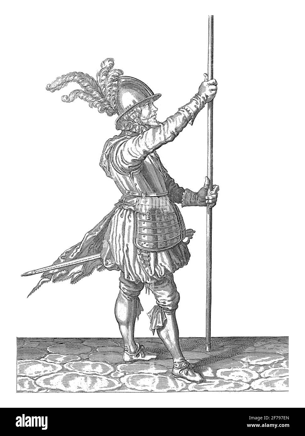 A soldier, full-length, to the right, holding a skewer (lance) with both hands upright slightly above the ground in front of him, vintage engraving. Stock Photo