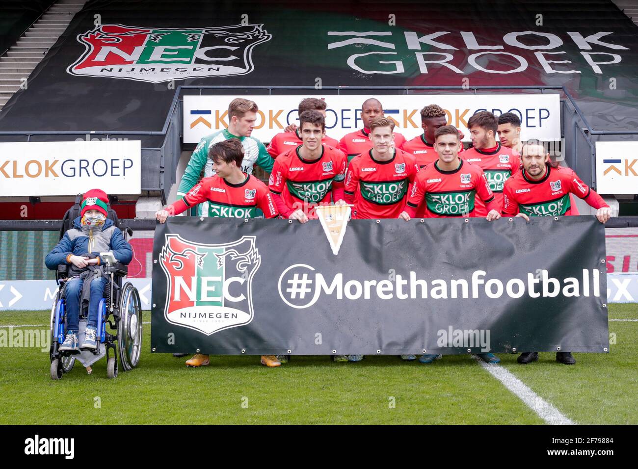 NIJMEGEN, NETHERLANDS - APRIL 5: Team NEC with a banner More Than Football and on the left an ill, sick child from the Amalia Kinderziekenhuis, Radbou Stock Photo