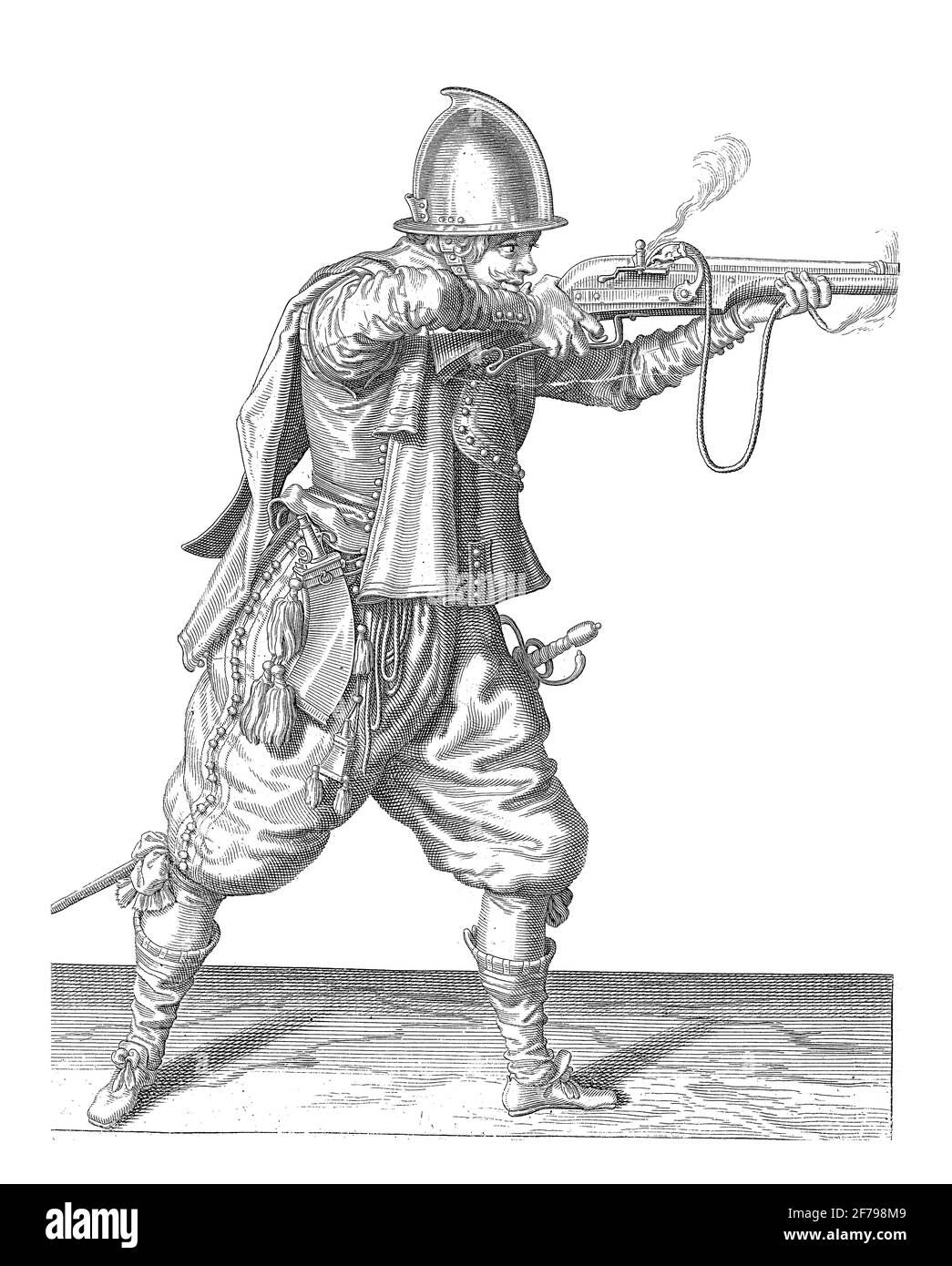 A soldier, full-length, to the right, holding a hold rudder (a particular type of firearm) horizontally with both hands, aim and fire, vintage engravi Stock Photo