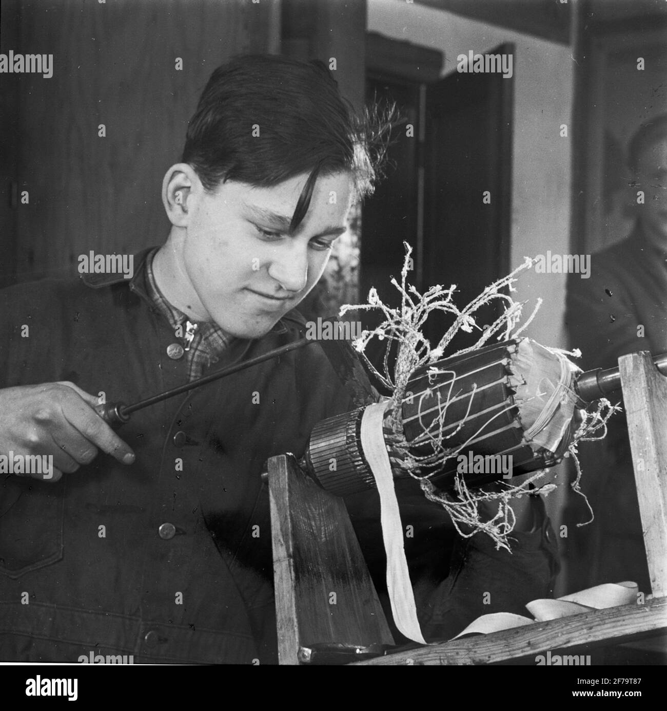 Light image regarding the youth prospects on the craft and industrial area. Young man, student, working in workshop. Stock Photo