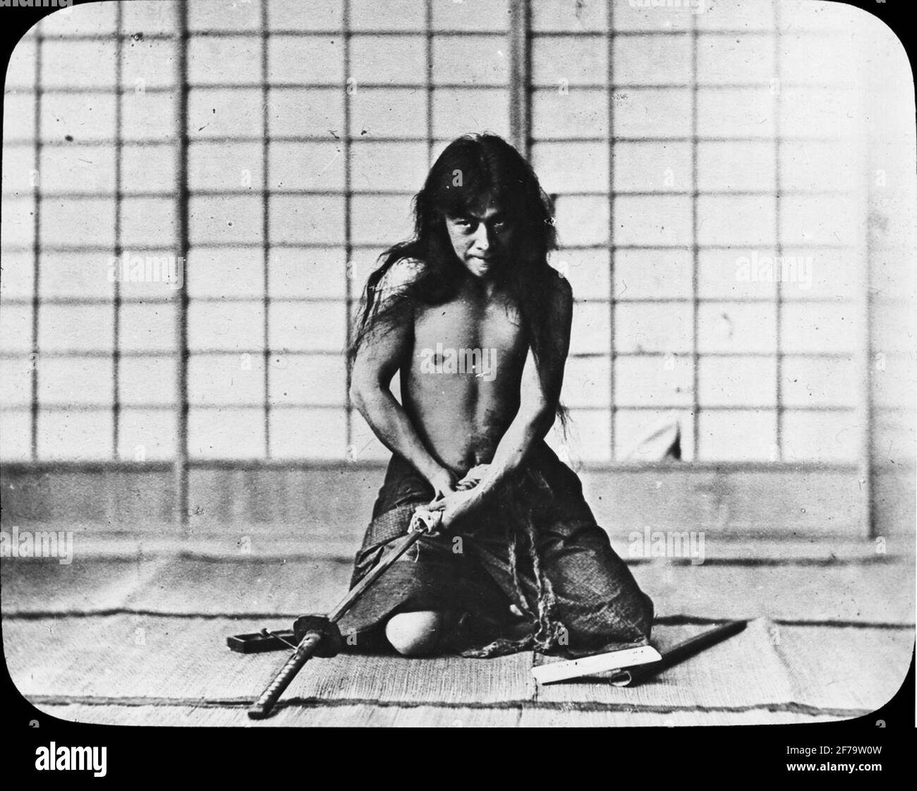 Samurai with sword. Possibly showing the execution of the ritual suicide so-called seppuku. Stock Photo