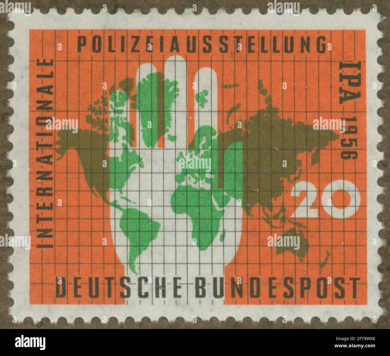 Stamp of Gösta Bodman's Philatelist Association, started in 1950.The stamp from West Germany, 1956. Motions of hand over world map. 'I. P. A. (Internat. Polizei Austellung in 1956). Stock Photo