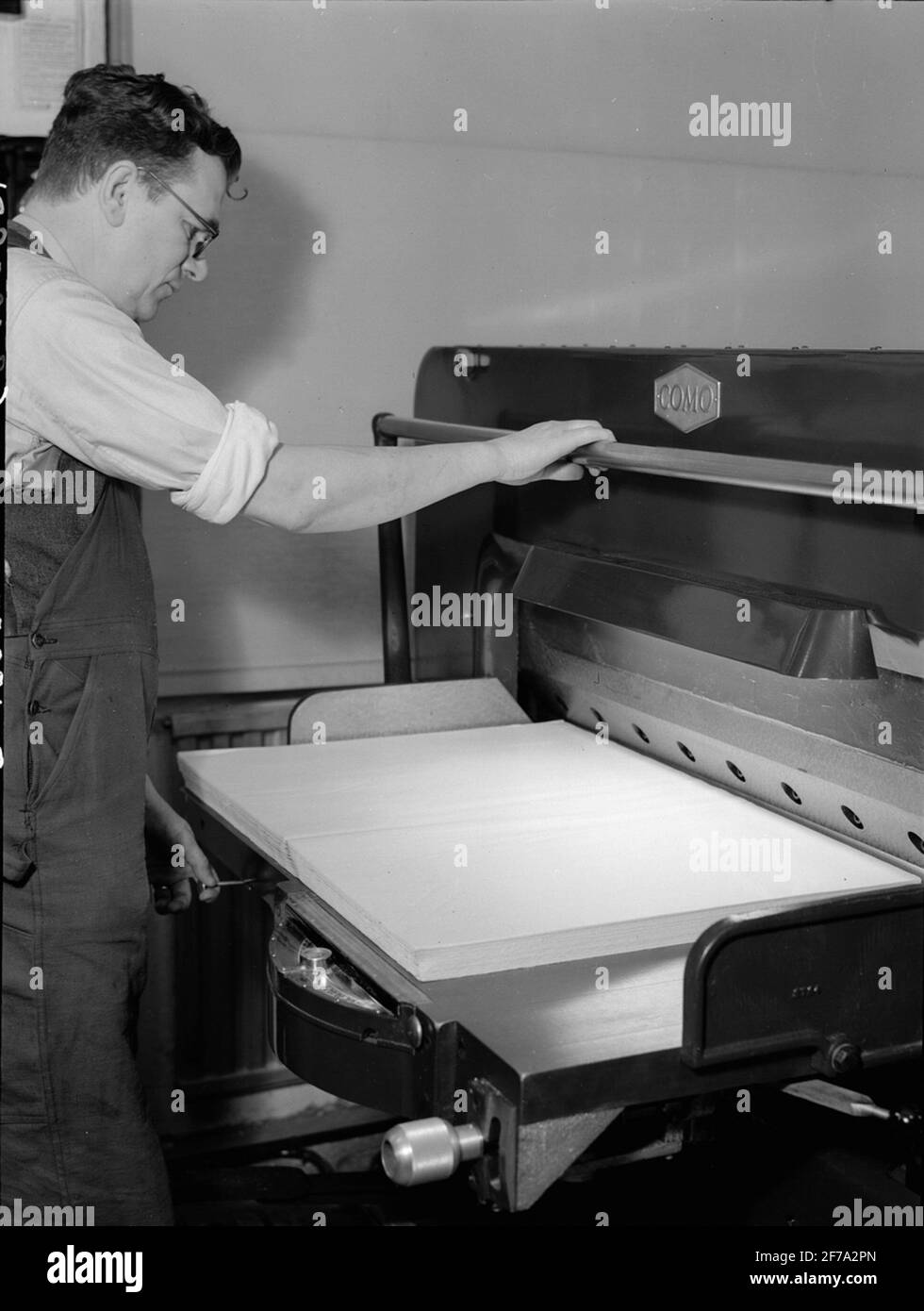 Picture from printing company. Man at paper press Stock Photo Alamy