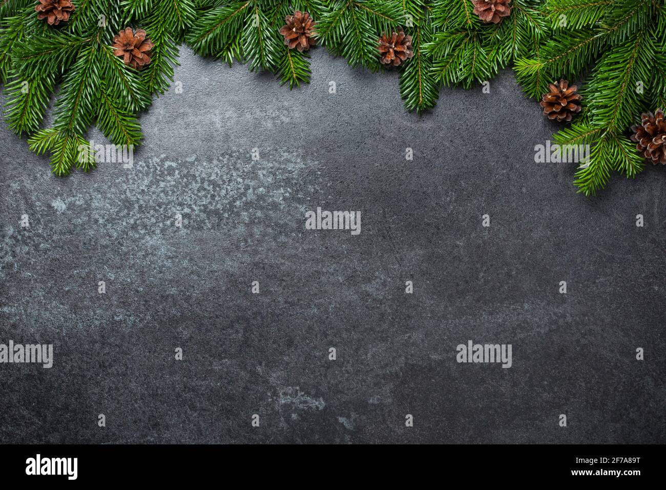 Christmas background with fir branches and cones on black Stock Photo ...