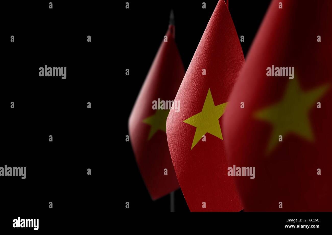 Small national flags of the Vietnam on a black background Stock Photo