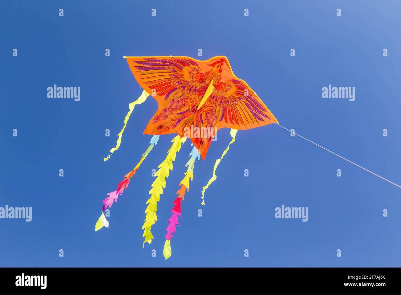 Colorful chinese kite flying in the blue sky. Stock Photo