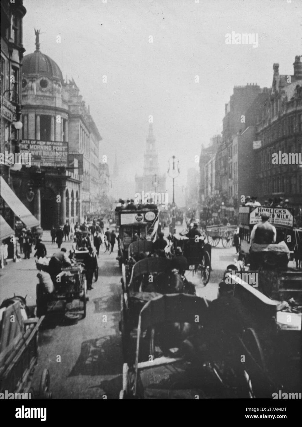 Skioptic image with motifs of busy street in London at the turn of the century 1900. The picture is taken on the beach at Waterloo Bridge, with St Clement Danes in the fund. The image has been stored in cardboard labeled :? Stock Photo