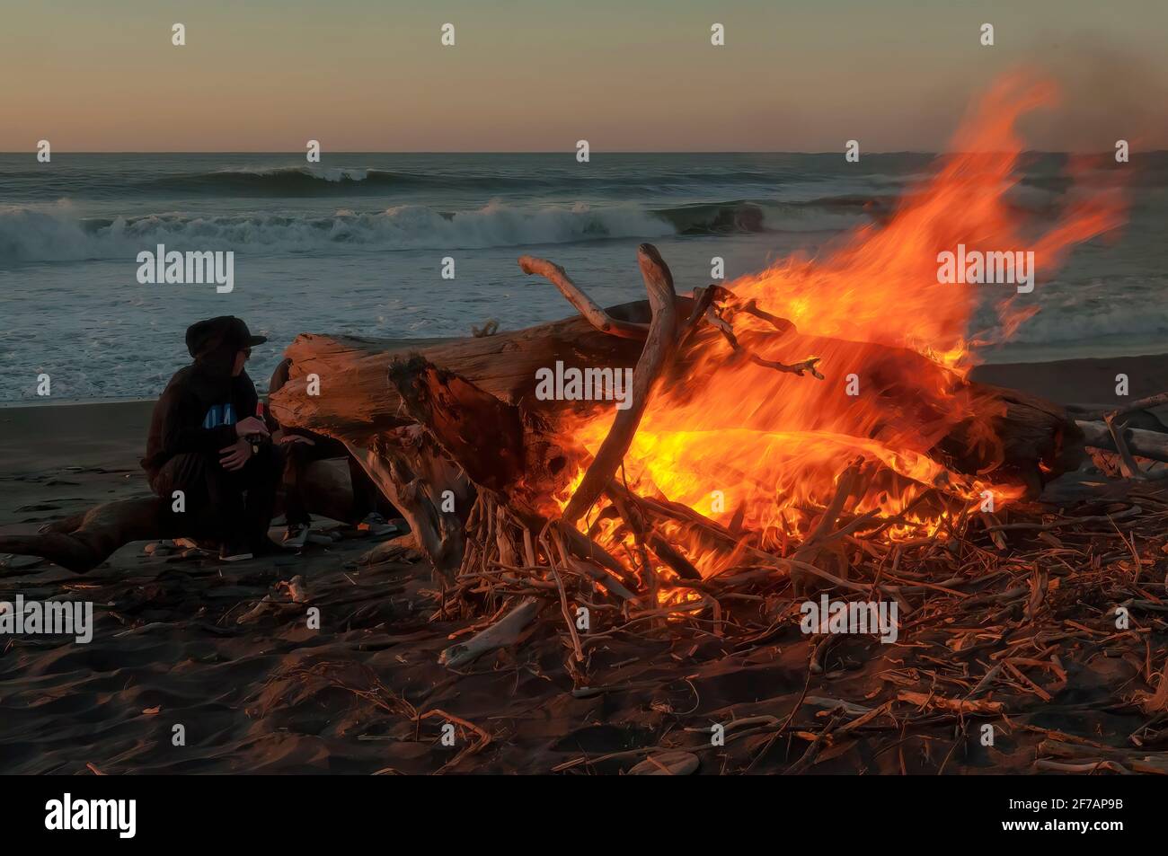 Keeping Warm on Hokitika Beach, South Island, New Zealand Stock Photo