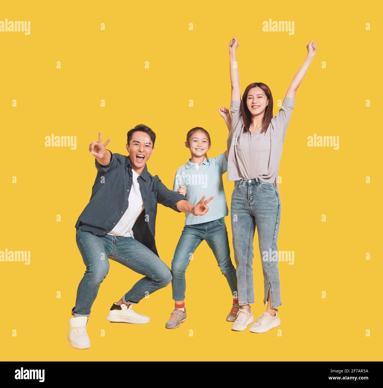 Happy young family with one child standing together Stock Photo