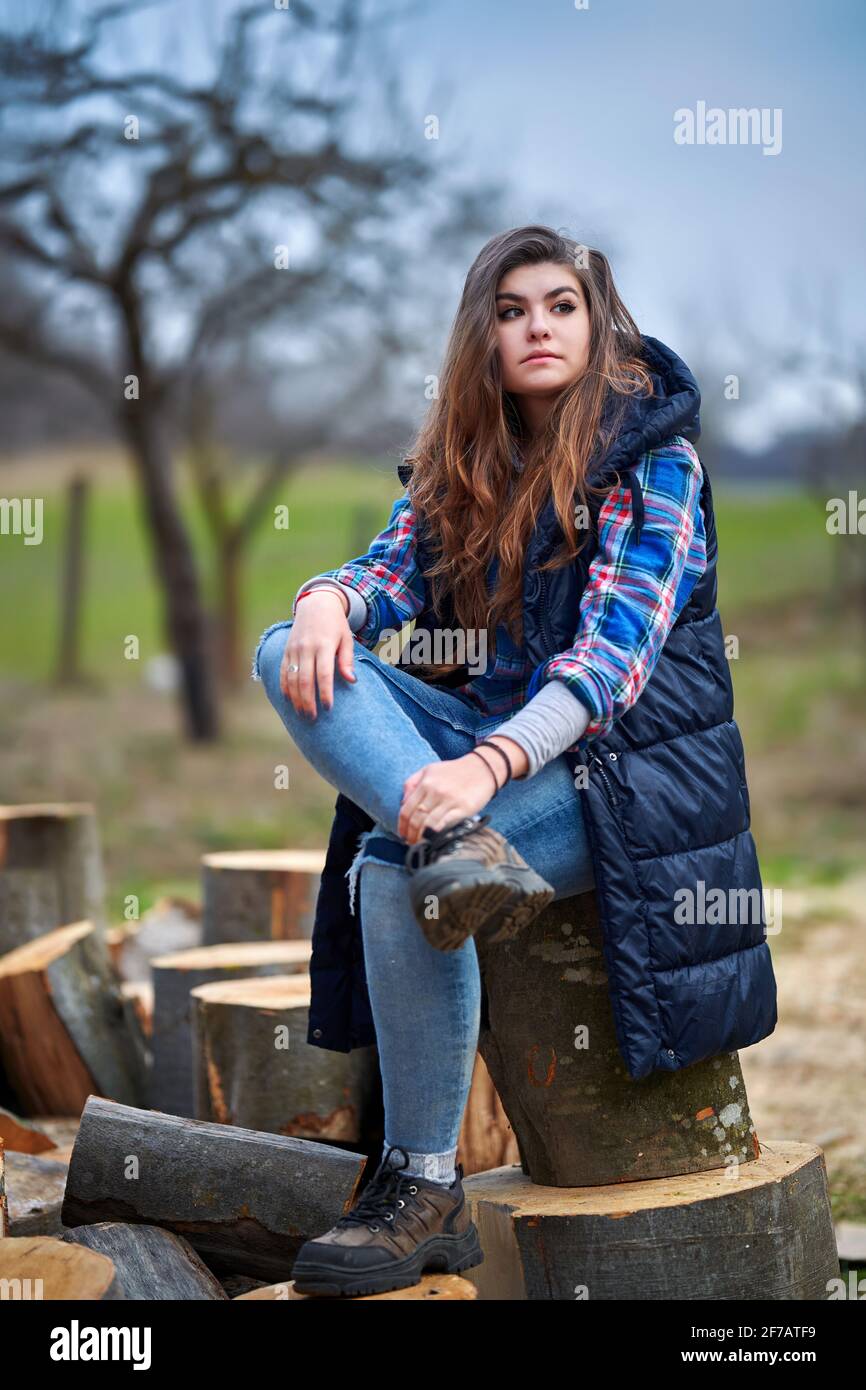 young woman in jeans, plaid shirt 