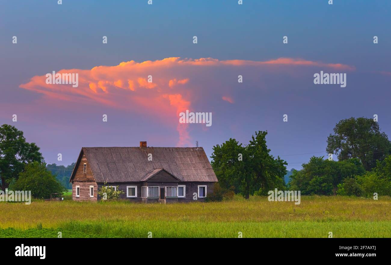 Storm tower clouds in the red evening sky Stock Photo