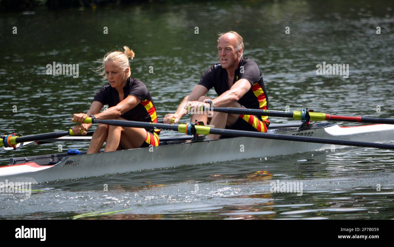 Older Couple competing in pairs sculling race. Stock Photo