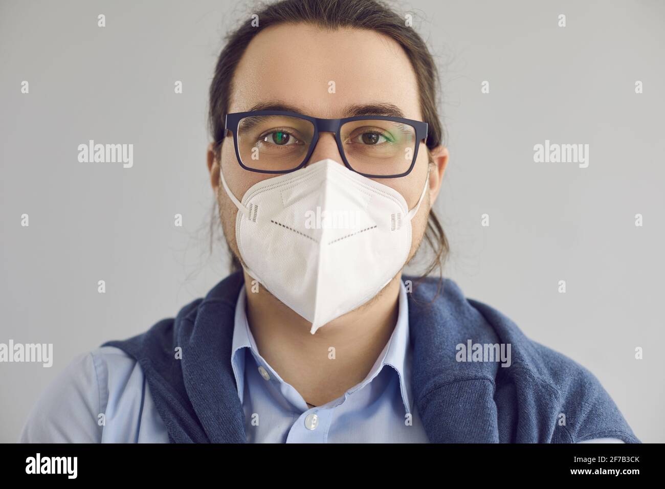 Headshot of man wearing KN95 face mask to protect himself from Covid 19