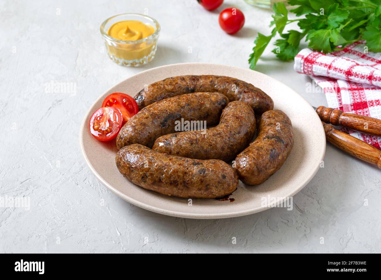 Homemade baked buckwheat sausages on a plate. Vegetarian menu Stock