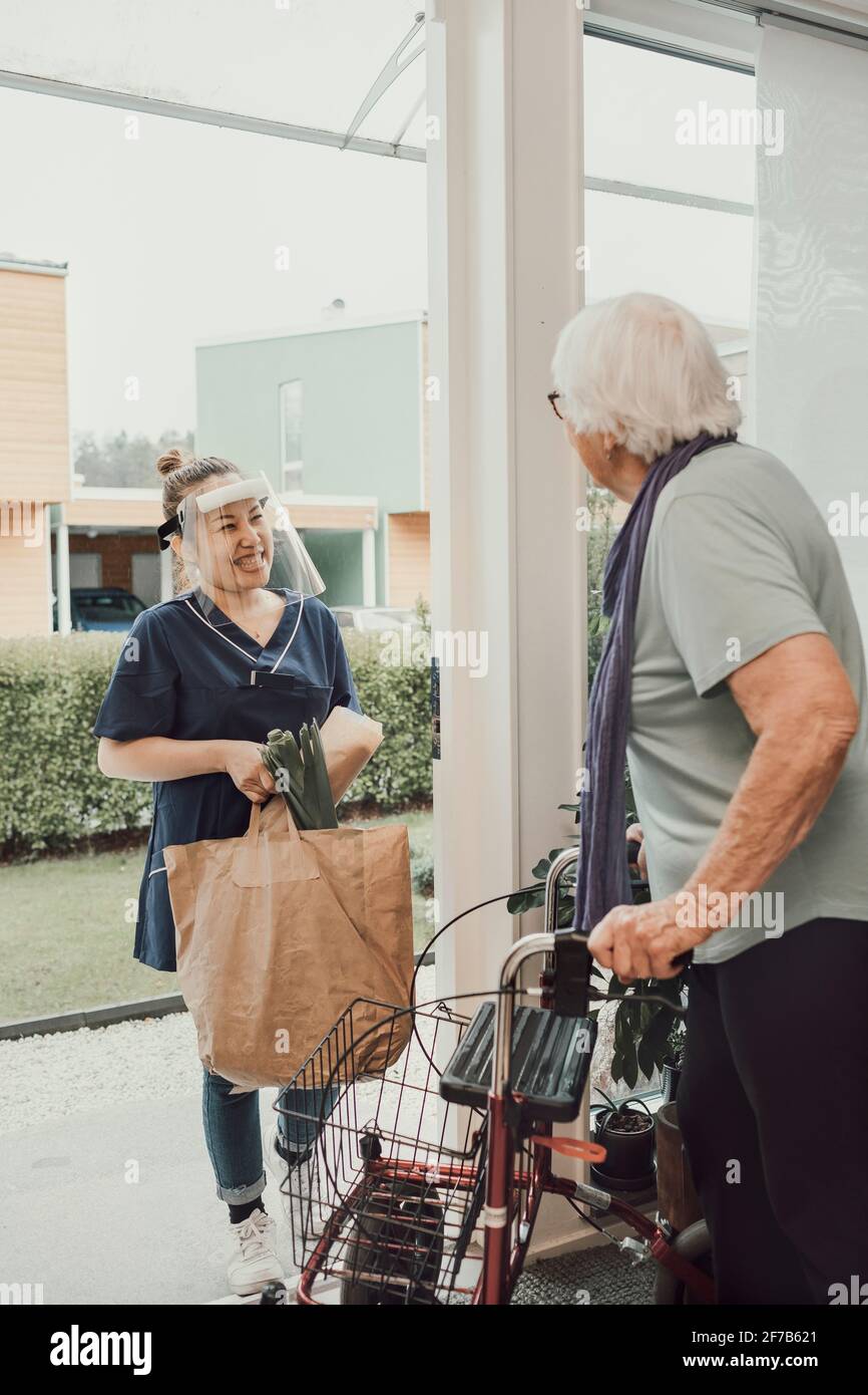 Home carer bringing senior woman shopping Stock Photo