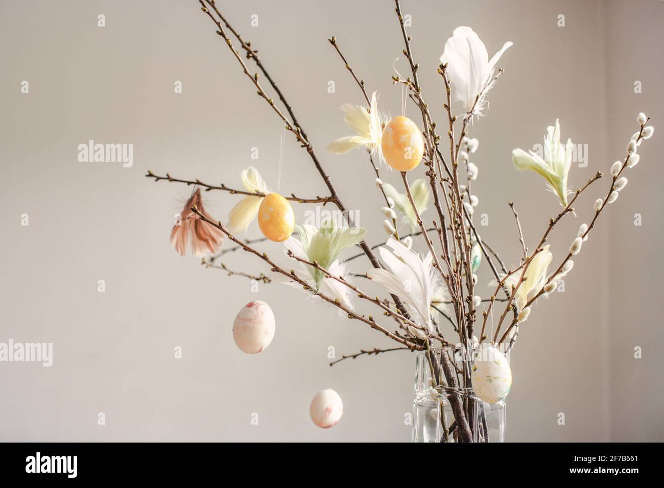 Twigs with hanging Easter eggs Stock Photo