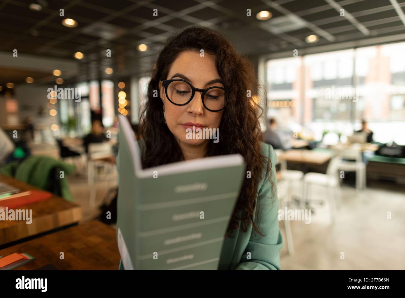 Businesswoman checking diary in cafe Stock Photo