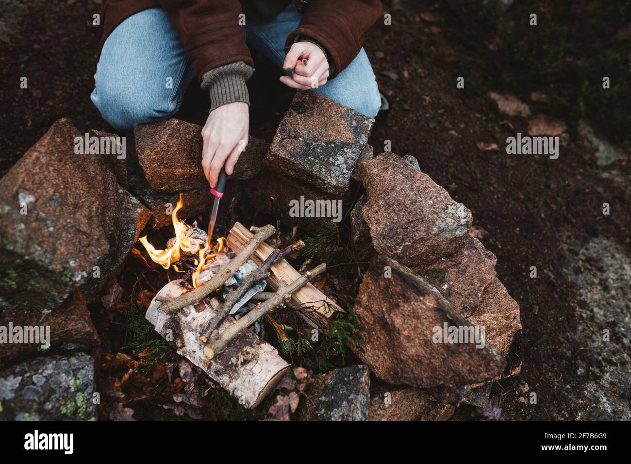 Woman preparing campfire Stock Photo