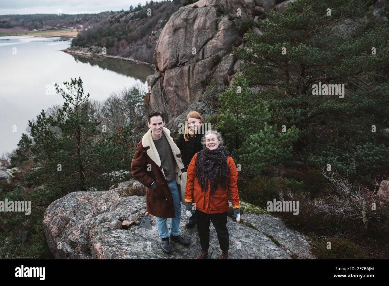 Smiling friends standing at sea Stock Photo