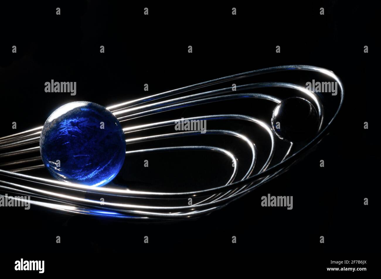 Planetary revolution in the kitchen universe with glass spheres and kitchen whip tool Stock Photo