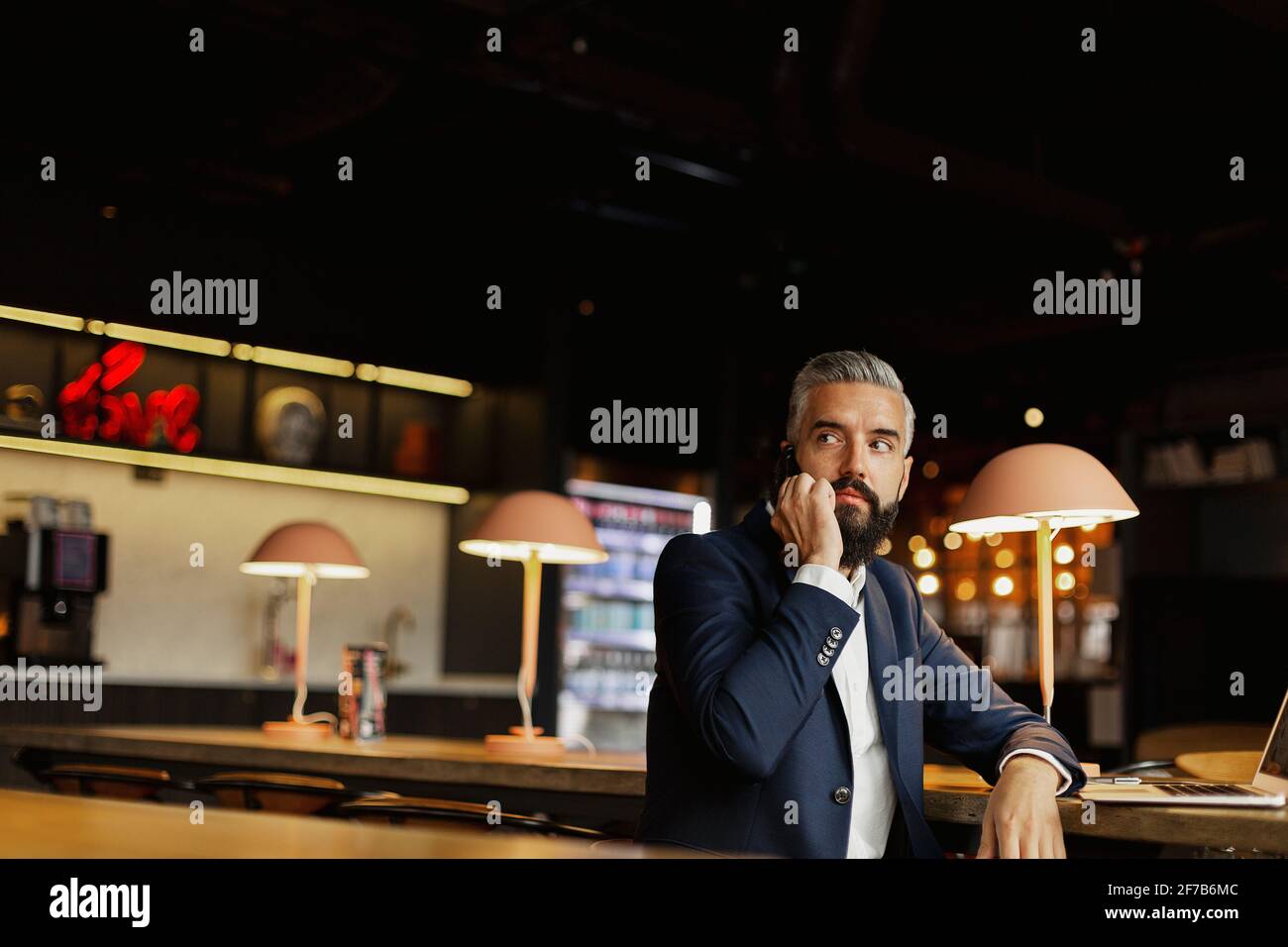 Businessman talking via cell phone in cafe Stock Photo