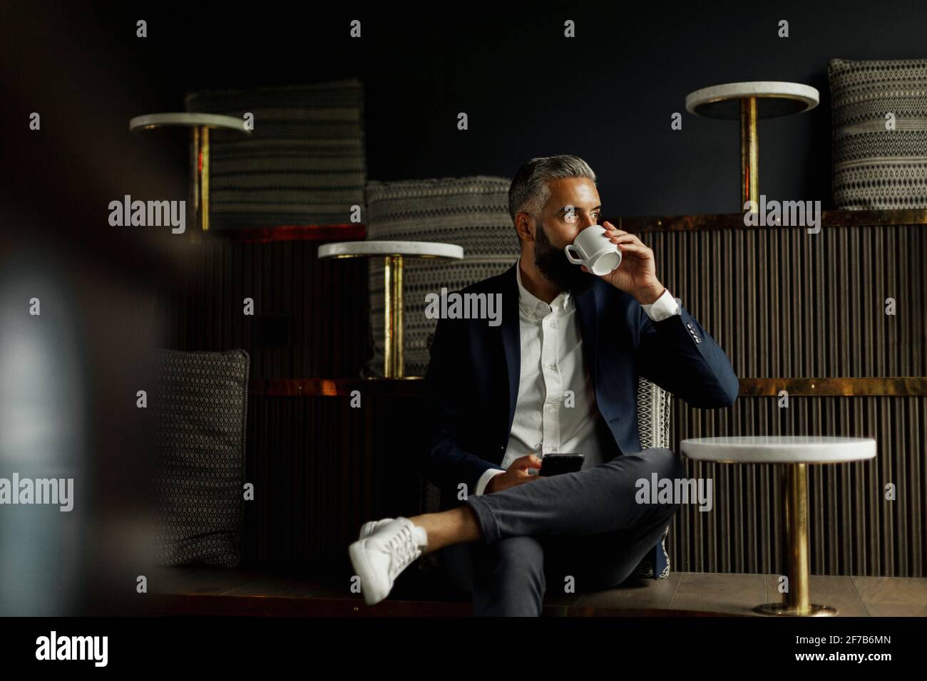 Businessman drinking coffee in cafe Stock Photo