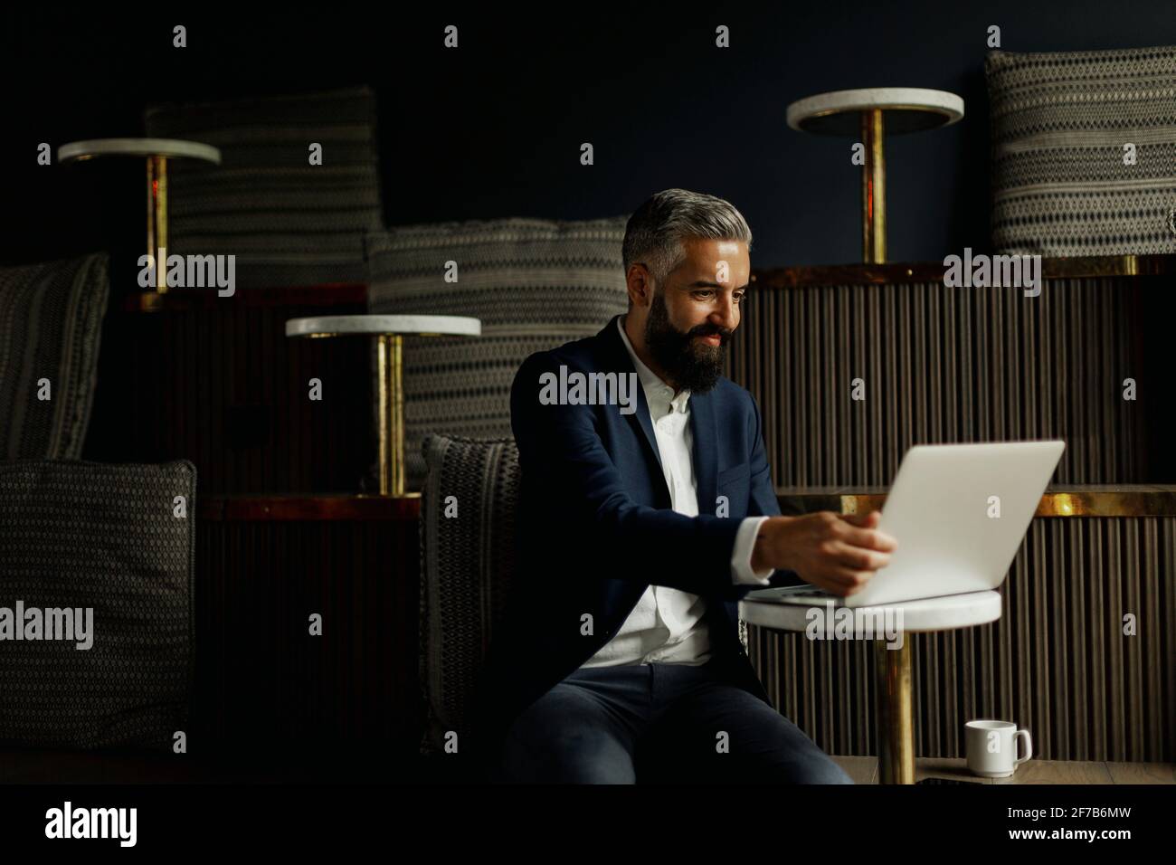 Businessman using laptop in cafe Stock Photo
