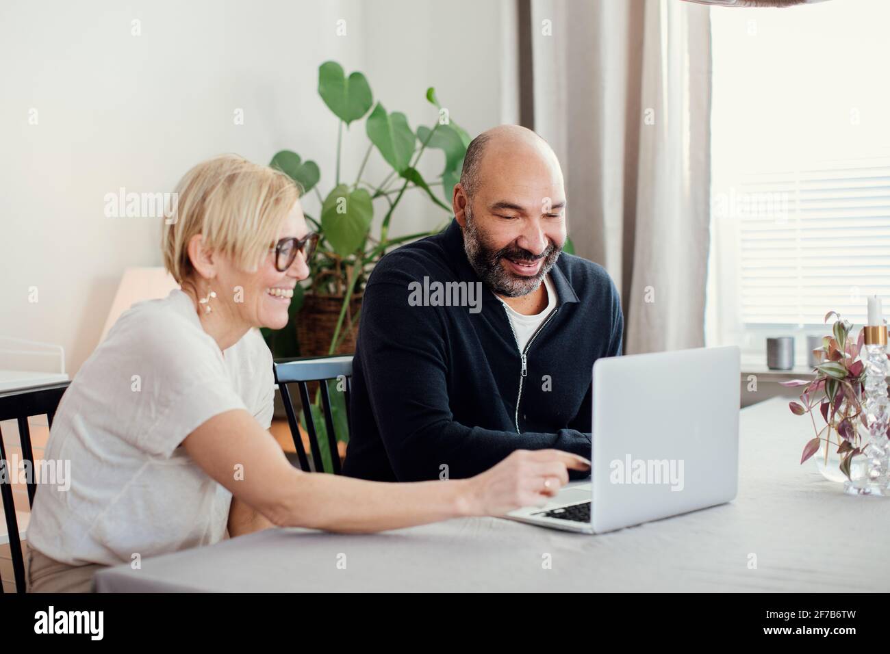 Couple using laptop at home Stock Photo