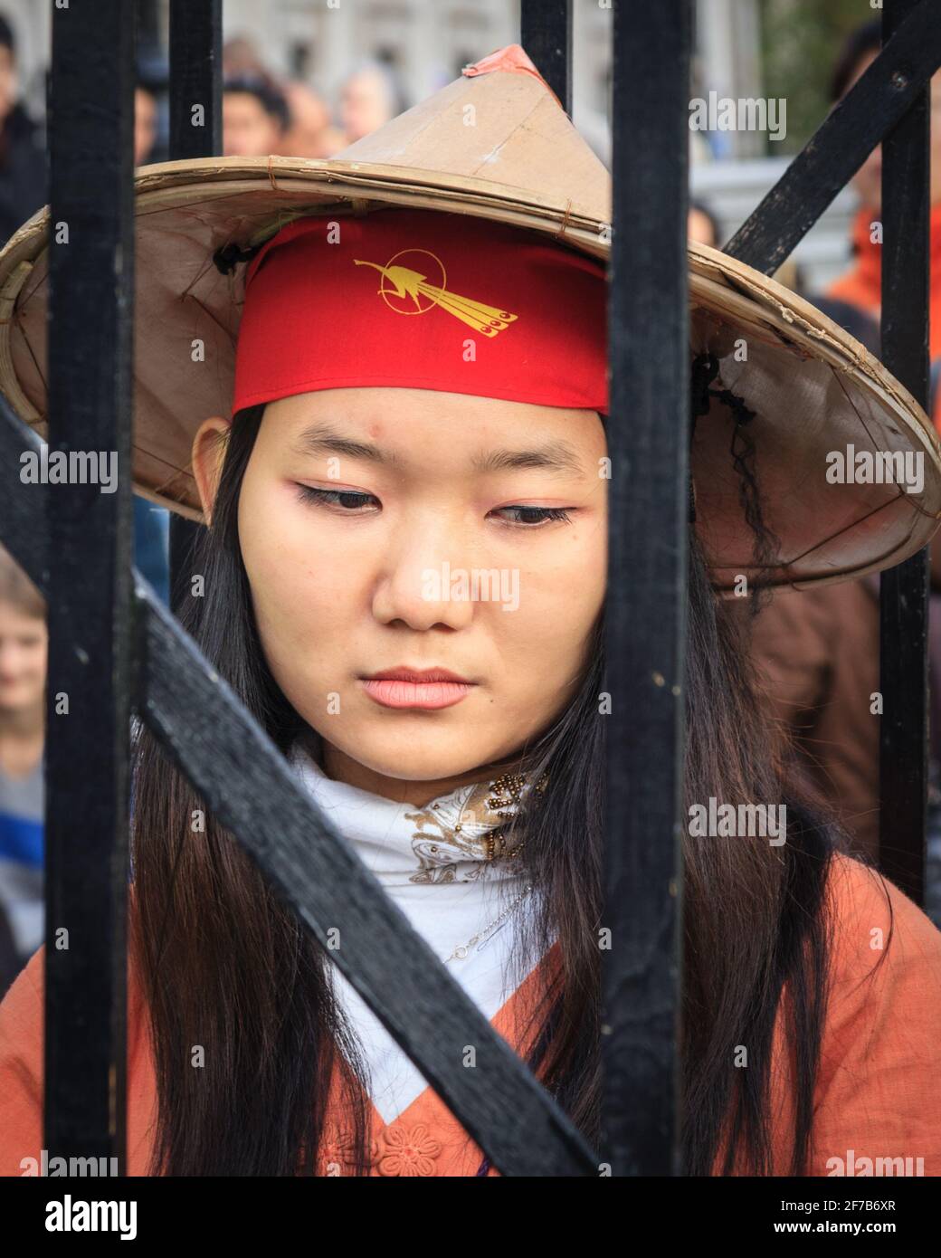 Female Burmese activist behind bars at 'Free Burma' protest on Trafalgar Square, on the day before the 2010 election there, London, UK Stock Photo