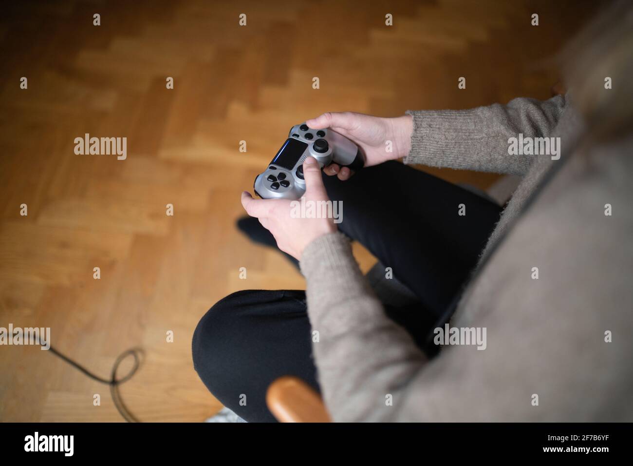 Woman's hands holding game control Stock Photo