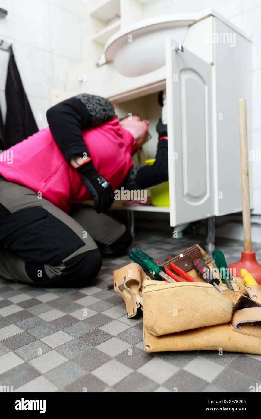 Female plumber repairing bathroom sink Stock Photo Alamy