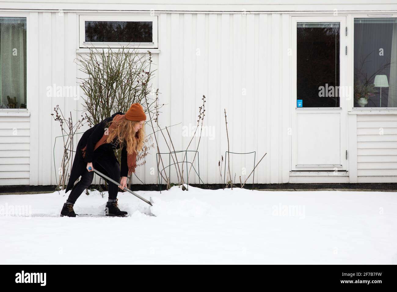 Woman shoveling snow hi-res stock photography and images - Alamy