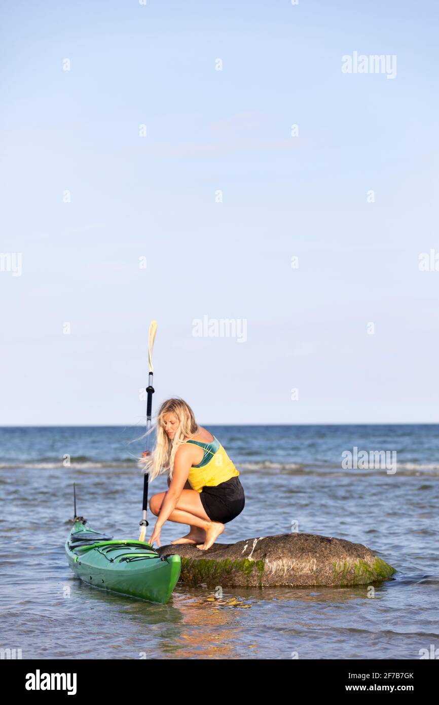 Woman kayaking on sea Stock Photo