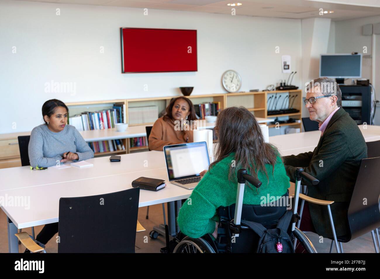 Disabled woman during meeting in office Stock Photo