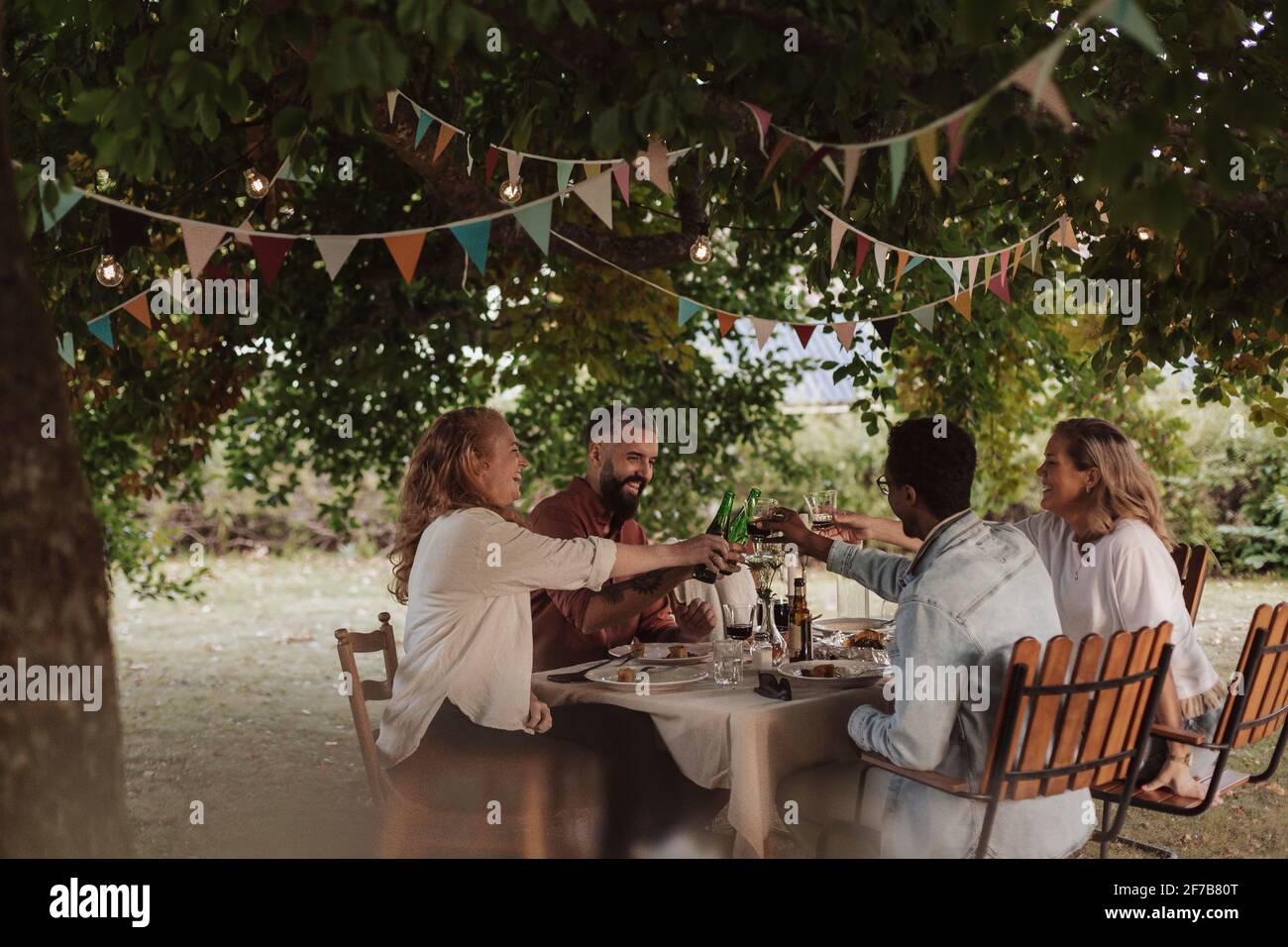 Friends having meal in garden Stock Photo