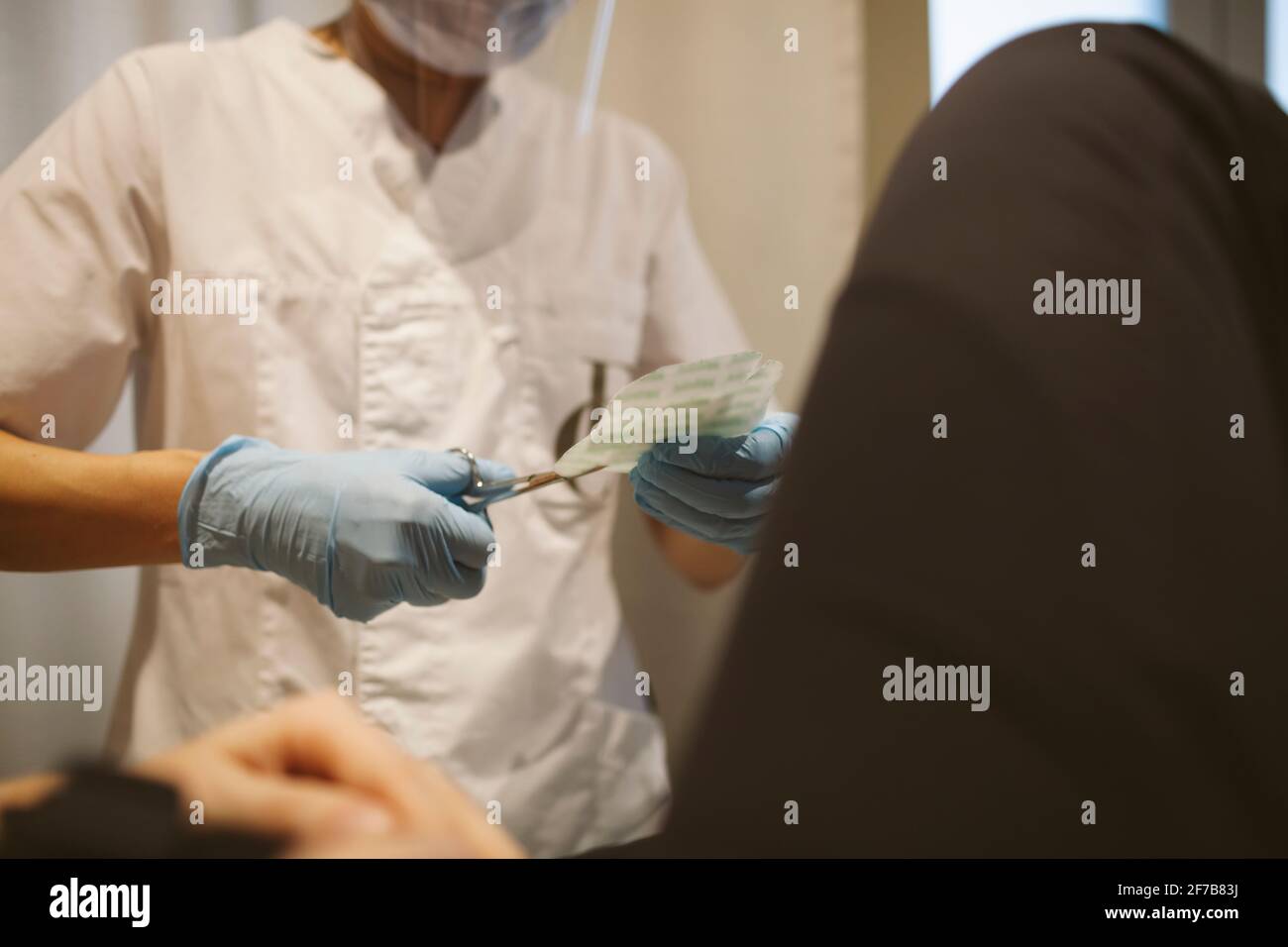 Doctor preparing bandage Stock Photo