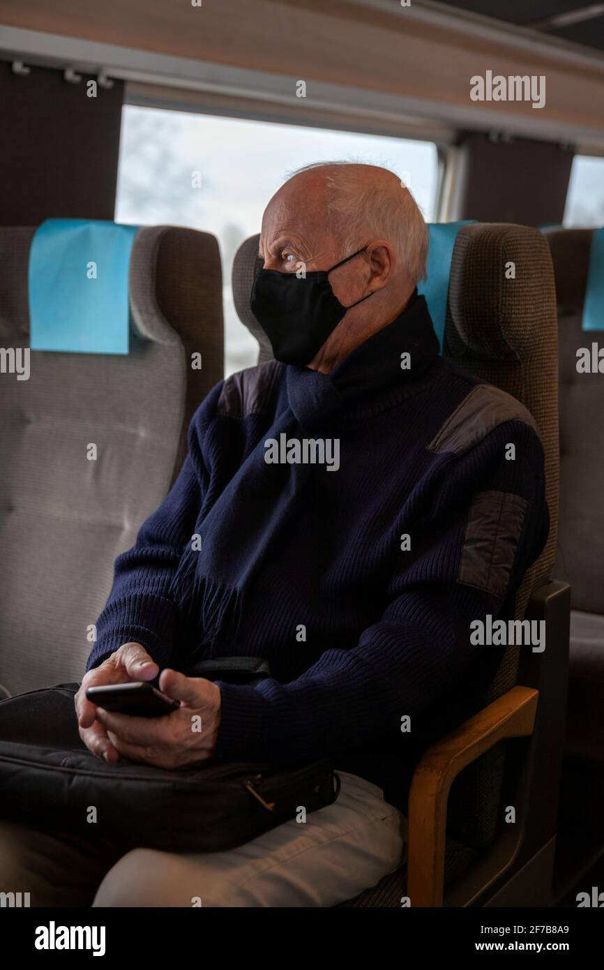 Senior man traveling by train Stock Photo