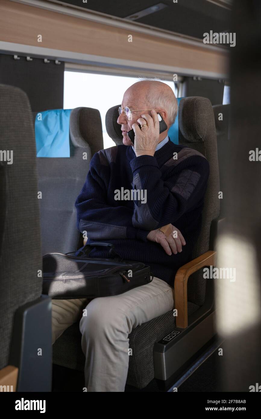 Senior man traveling by train Stock Photo