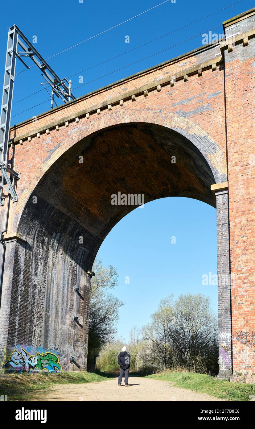 A man looks up at the newly electrified railway line on the victorian
