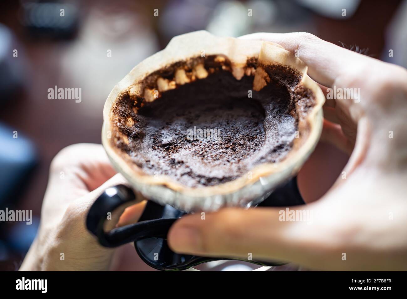 Used coffee ground left in a coffee dripper. Coffee grounds can be used as a fertilizer. Stock Photo