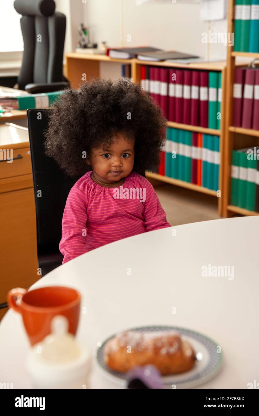 Cute girl sitting in office Stock Photo