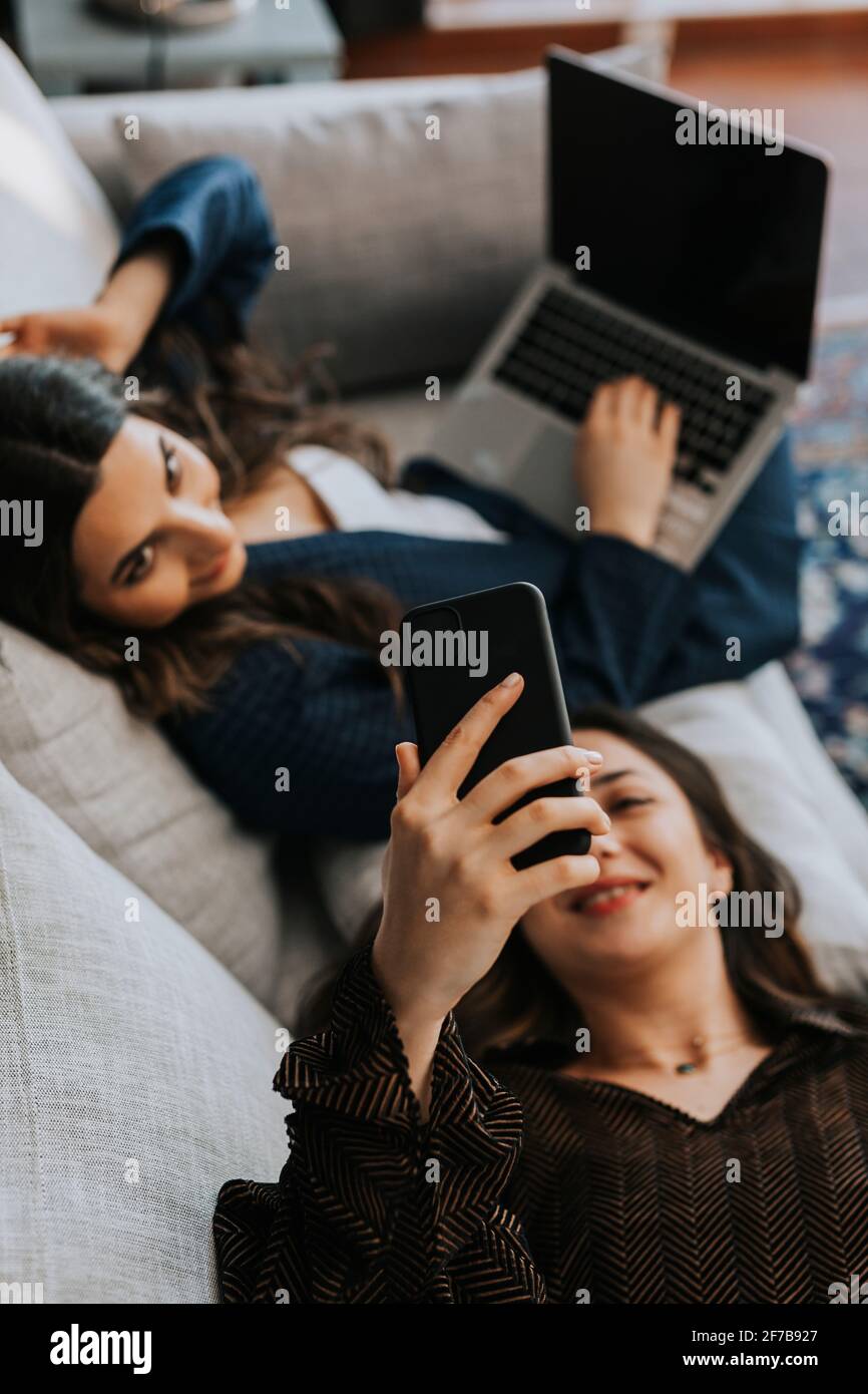 Female coworkers on sofa Stock Photo