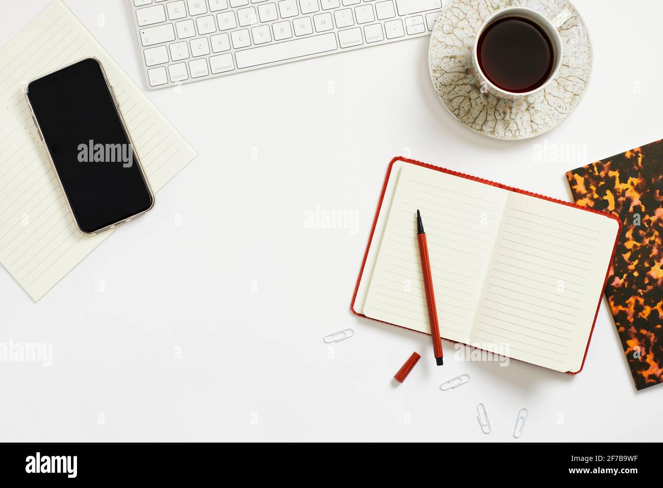 Coffee and notepad on desk Stock Photo